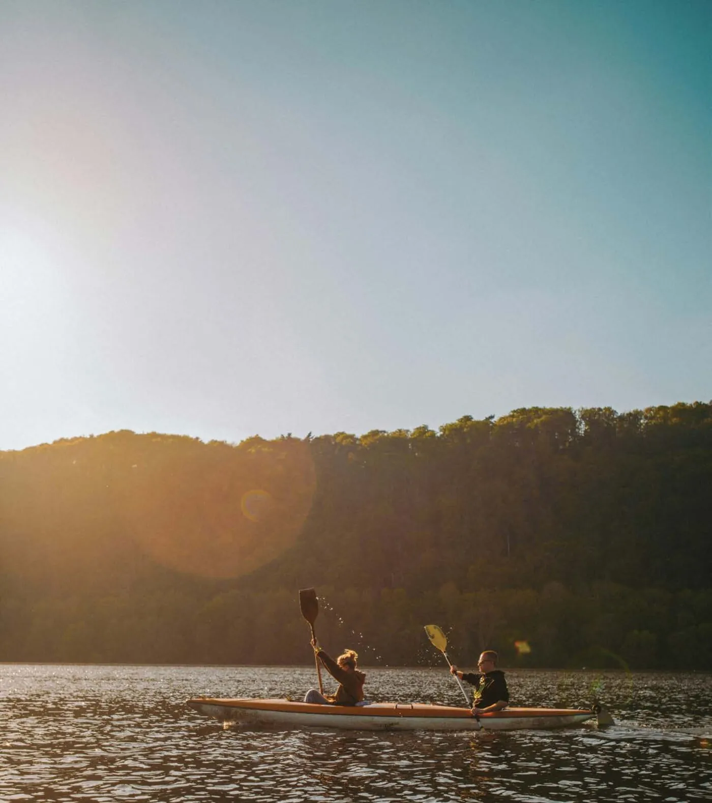 Two people kayaking on the river at sunset near Wellwood